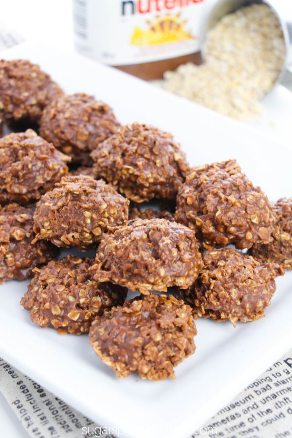 no bake nutella cookies on a white platter with ingredients to make the recipe in the background