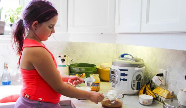 child preparing marinade to make chipotle chicken