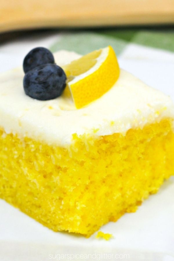 a square of lemon sheet cake on a white plate