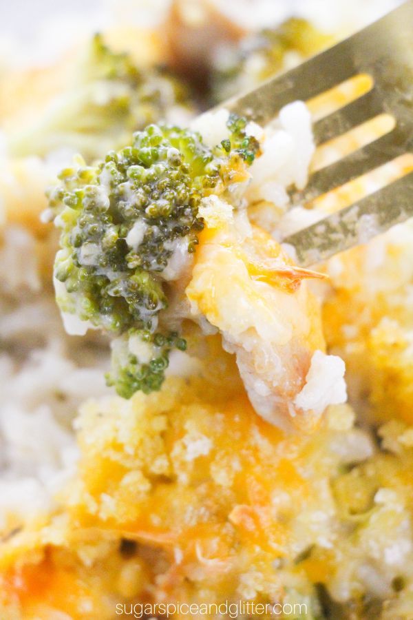fork full of a bite of broccoli chicken casserole